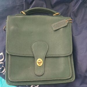 This is a vintage Coach Willis 9927 shoulder bag in dark green leather with gold